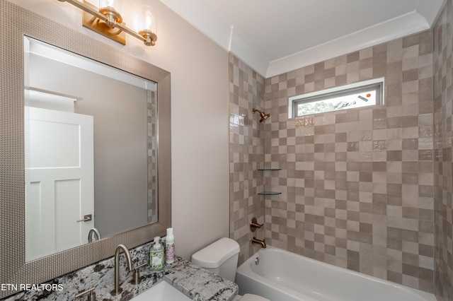 full bathroom featuring toilet, vanity, and tiled shower / bath combo