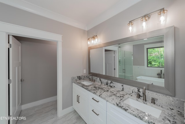 bathroom with crown molding, independent shower and bath, and vanity