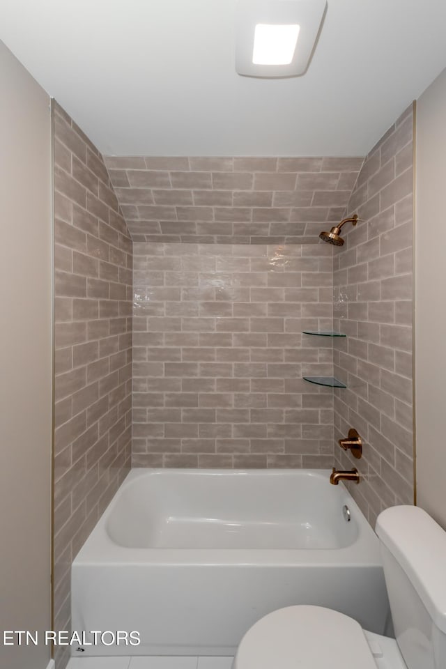 bathroom with toilet and tiled shower / bath combo