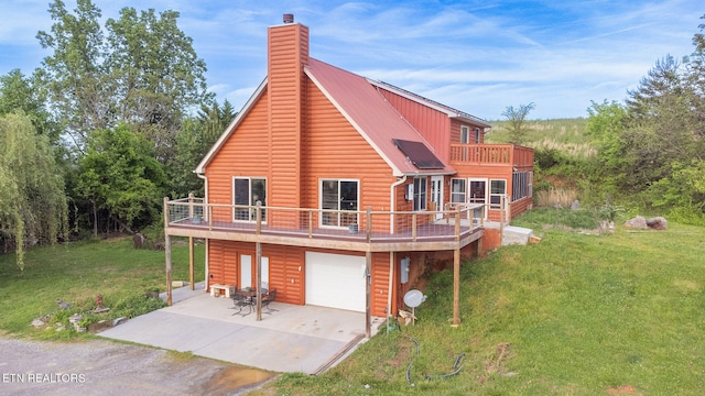 back of property featuring a garage and a yard