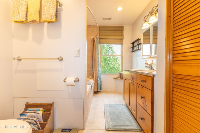 full bathroom with shower / tub combo with curtain, vanity, tile floors, and toilet