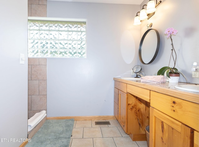 bathroom with tile floors and dual bowl vanity