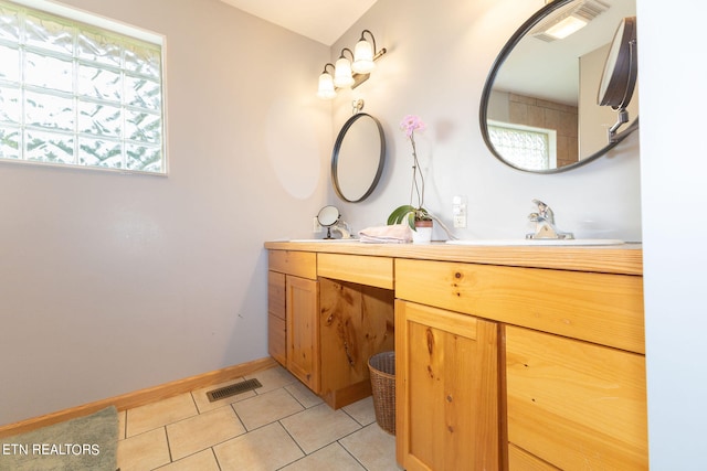 bathroom featuring tile floors and vanity