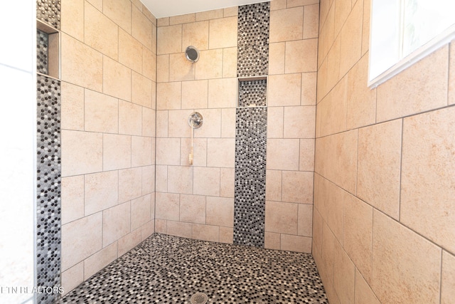 bathroom with tiled shower