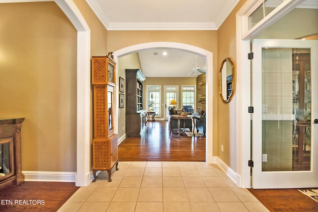 hallway with crown molding and tile flooring