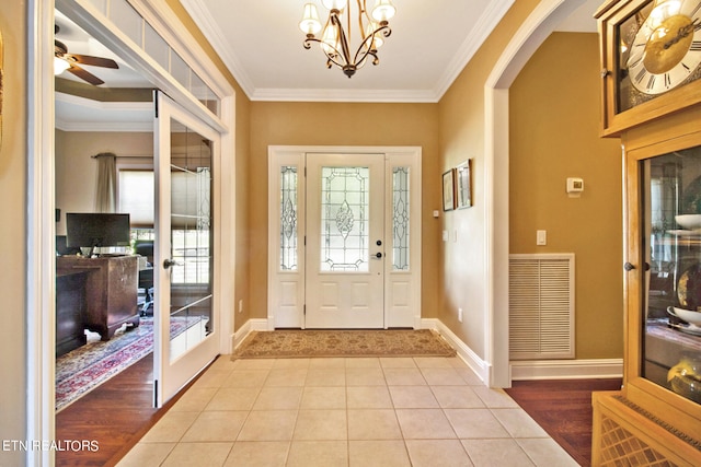 entryway with a wealth of natural light and crown molding