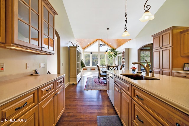 kitchen with sink, dishwasher, decorative light fixtures, dark hardwood / wood-style floors, and vaulted ceiling