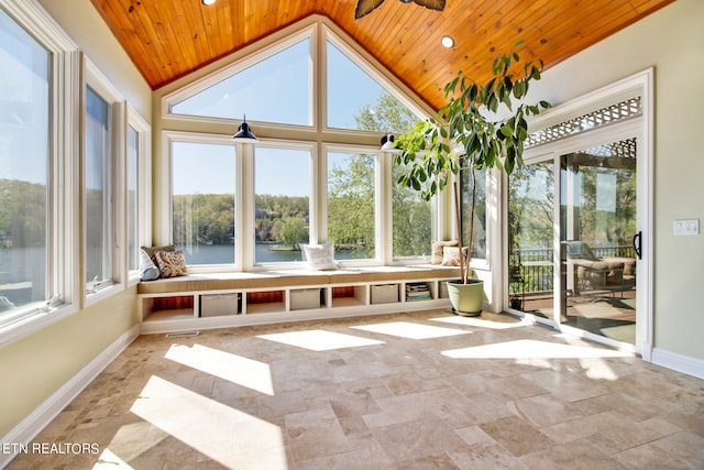 unfurnished sunroom featuring wood ceiling, plenty of natural light, vaulted ceiling, and ceiling fan