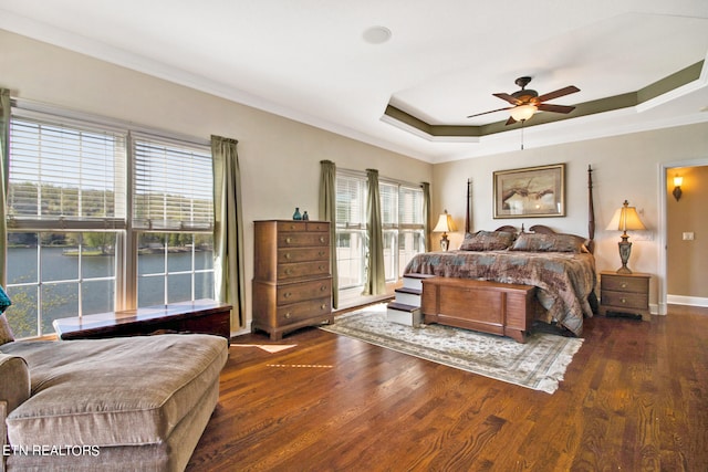 bedroom featuring ornamental molding, dark hardwood / wood-style flooring, and multiple windows