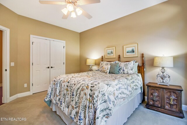 bedroom featuring ceiling fan, a closet, and carpet floors