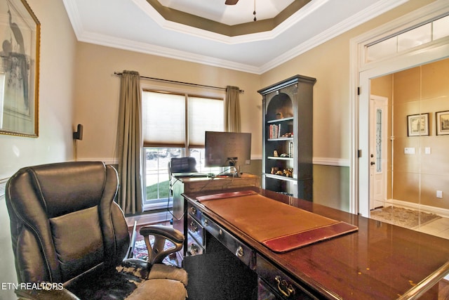 tiled office with crown molding, ceiling fan, and a tray ceiling