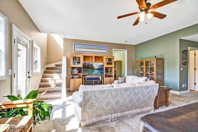 carpeted living room featuring ceiling fan