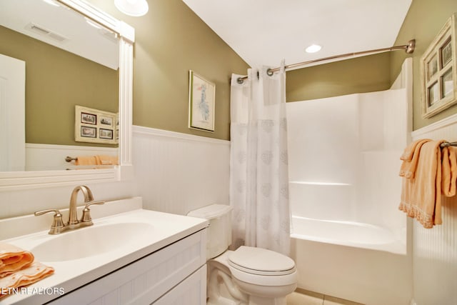 full bathroom with tile floors, vanity, toilet, and shower / tub combo with curtain