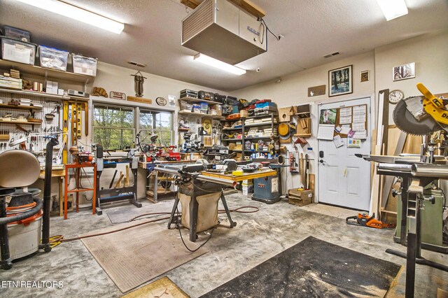 misc room with a workshop area and a textured ceiling