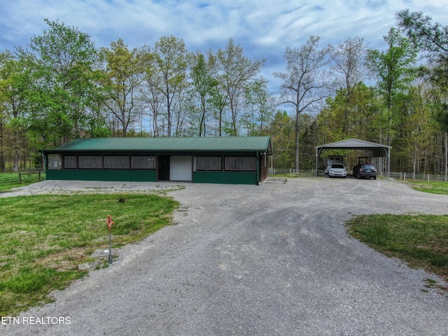 view of front of house featuring an outdoor structure and a carport