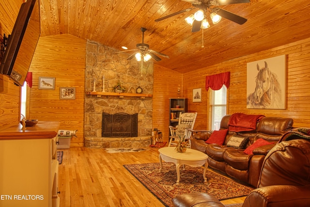 living room with lofted ceiling, light hardwood / wood-style floors, and wooden walls