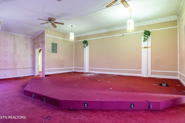 spare room featuring lofted ceiling, carpet floors, and ceiling fan