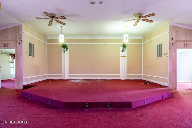 miscellaneous room featuring wooden walls, carpet, and vaulted ceiling