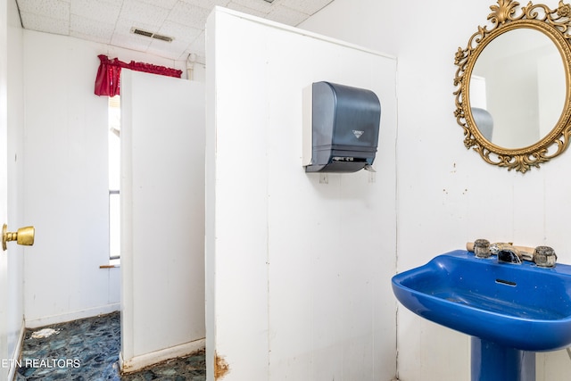 bathroom with sink and a paneled ceiling