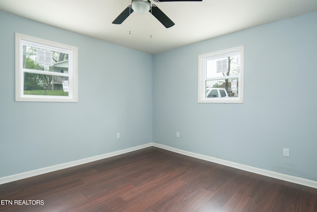 unfurnished room with dark hardwood / wood-style flooring and ceiling fan