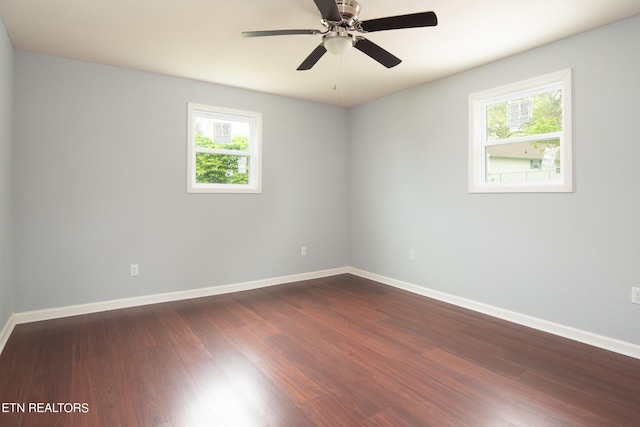 empty room with wood-type flooring, a wealth of natural light, and ceiling fan