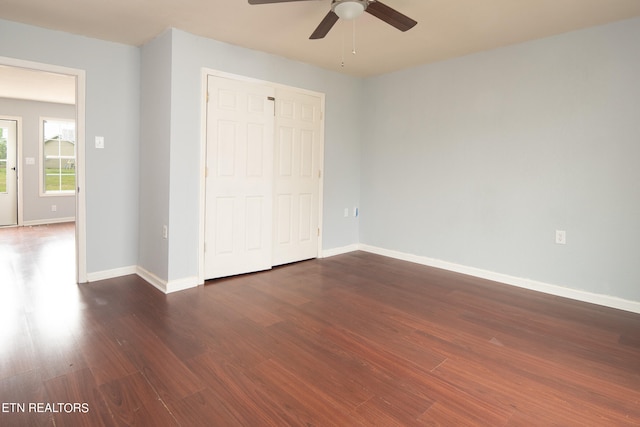 unfurnished bedroom with a closet, ceiling fan, and dark hardwood / wood-style floors