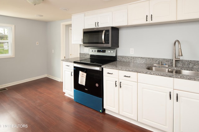 kitchen featuring stone counters, stainless steel appliances, dark wood-type flooring, white cabinetry, and sink