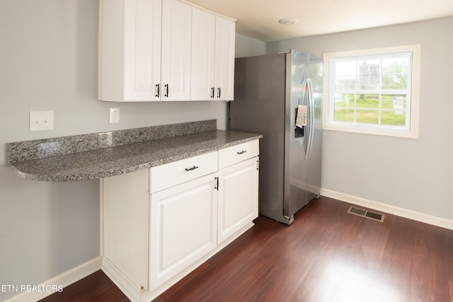 kitchen featuring stainless steel fridge with ice dispenser, white cabinets, and dark wood-type flooring