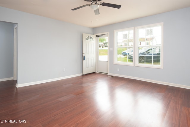 spare room featuring dark hardwood / wood-style floors and ceiling fan