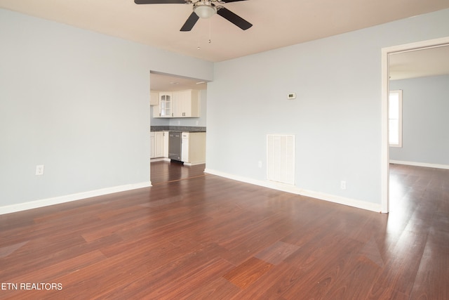 unfurnished living room featuring ceiling fan and dark wood-type flooring