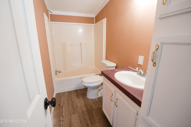 full bathroom with toilet, wood-type flooring, a textured ceiling, vanity, and tub / shower combination