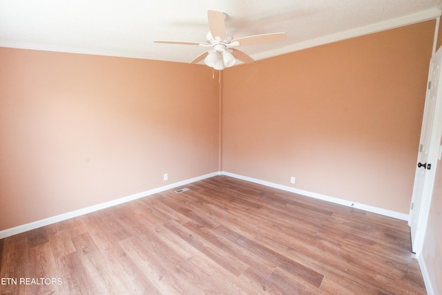 spare room featuring ornamental molding, wood-type flooring, and ceiling fan