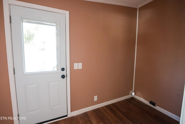 entryway featuring crown molding and dark hardwood / wood-style floors