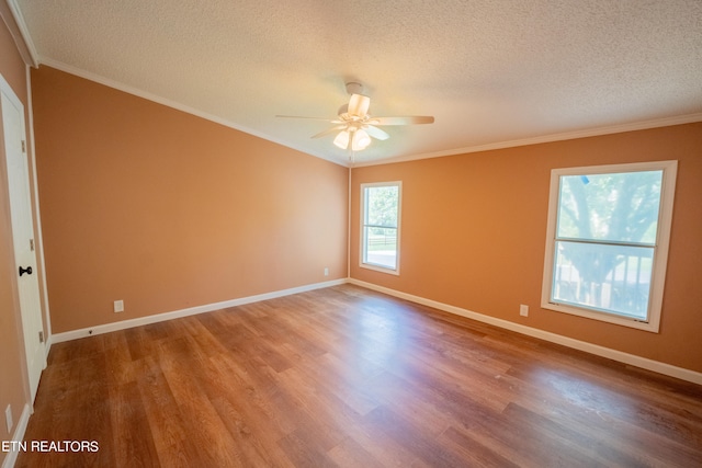 empty room with wood-type flooring, ceiling fan, and crown molding