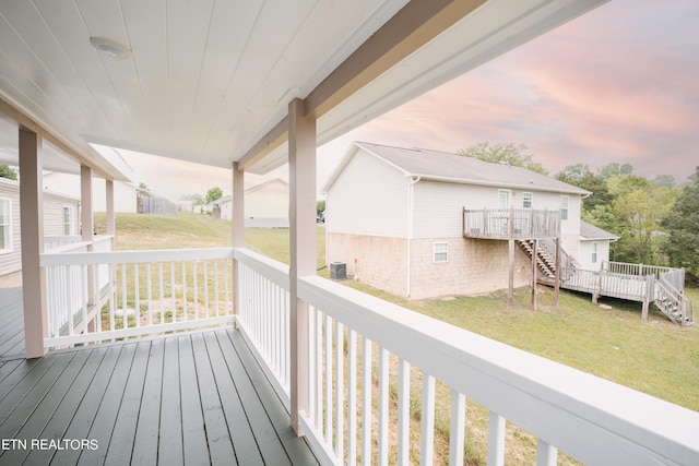 wooden terrace featuring a yard