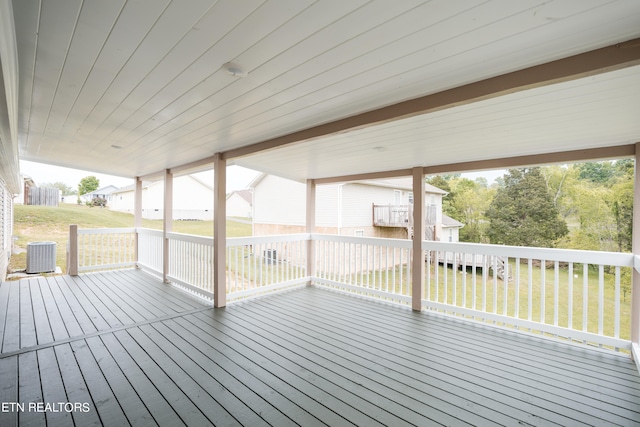 wooden deck with central AC and a lawn