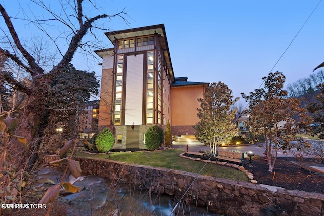 view of back house at dusk