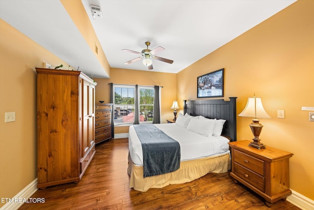 bedroom featuring ceiling fan, dark hardwood / wood-style floors, and vaulted ceiling