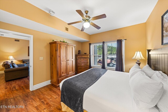 bedroom featuring ceiling fan and dark hardwood / wood-style flooring