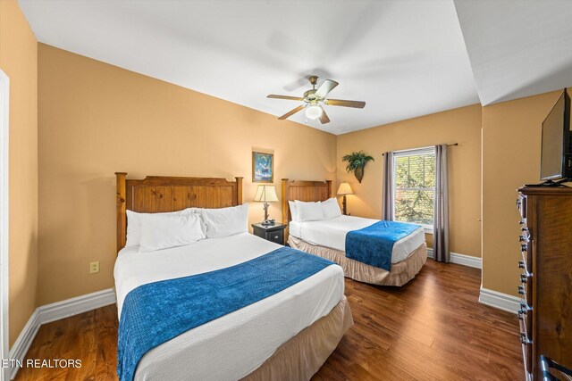 bedroom with dark wood-type flooring and ceiling fan