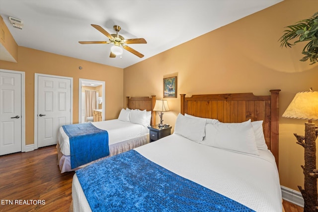 bedroom featuring ceiling fan, ensuite bath, and dark hardwood / wood-style floors