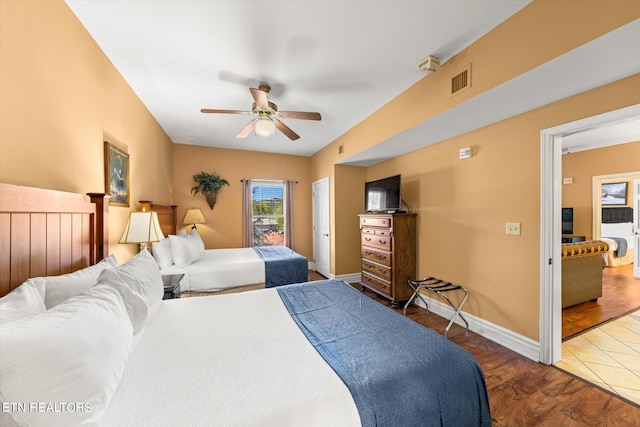 tiled bedroom with ceiling fan