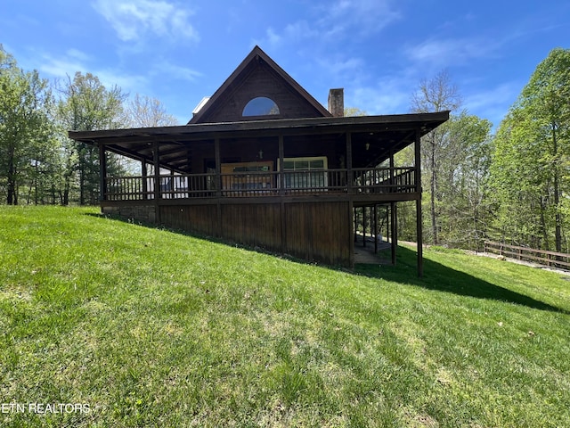 back of house featuring a yard and a deck