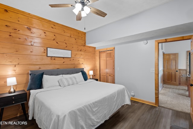 carpeted bedroom with a closet, ceiling fan, and a barn door