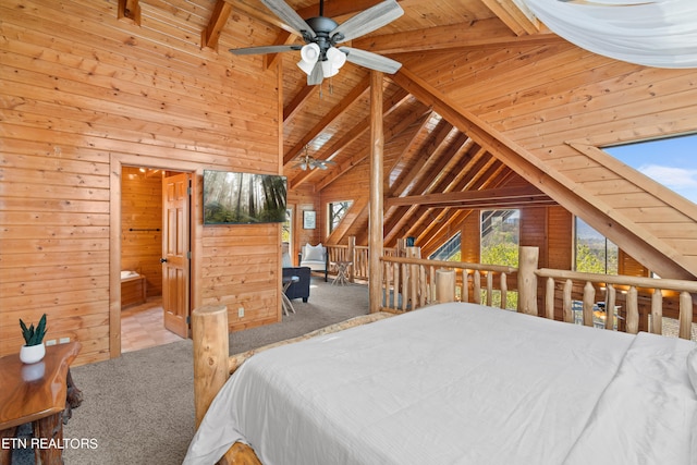 bedroom featuring wood walls, beamed ceiling, carpet floors, wooden ceiling, and ceiling fan