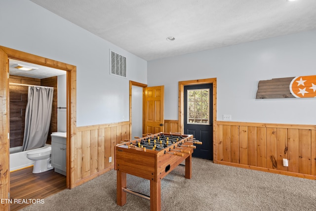 recreation room with dark carpet