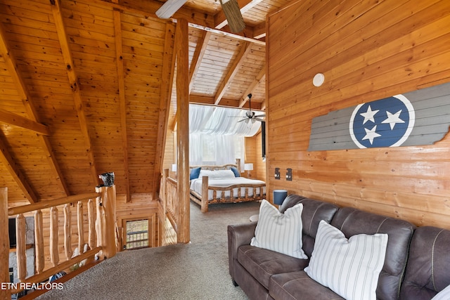 carpeted bedroom with wooden walls, lofted ceiling with beams, and wooden ceiling