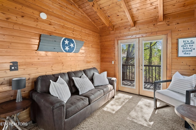 living room featuring wooden walls, carpet floors, french doors, vaulted ceiling with beams, and wood ceiling