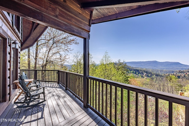 wooden deck with a mountain view