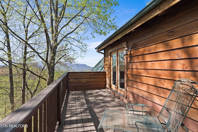 wooden deck featuring a mountain view